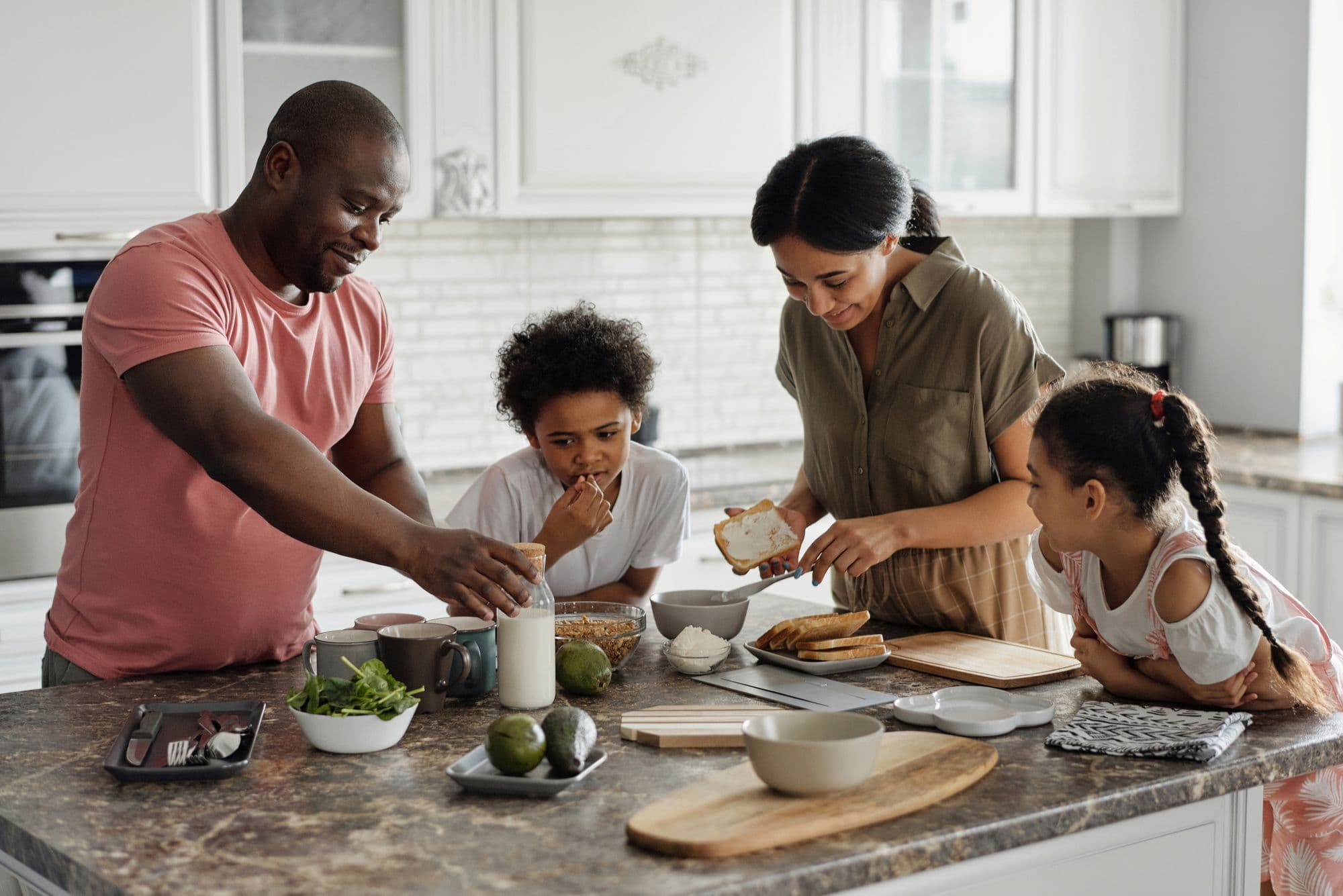 A family making lunches together at the kitchen counter